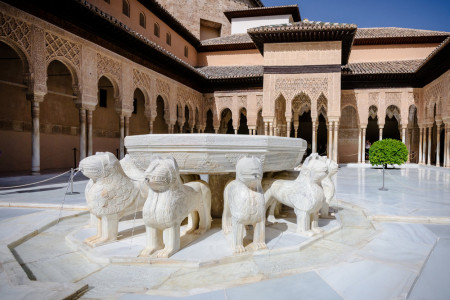 the Court of Lions at the 13th century Alhambra Palace in Granada Spain. Beautiful arches and Arabesque Architecture